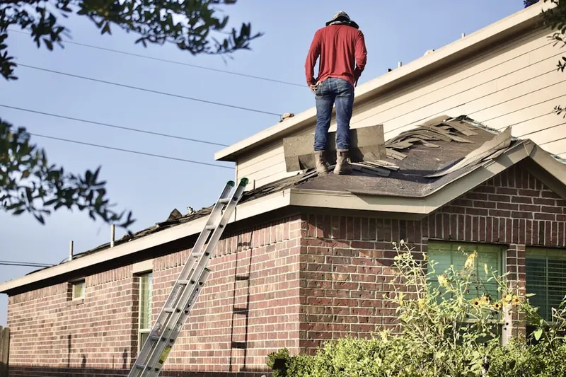 Professional roofer working on a residential roof in Grambling